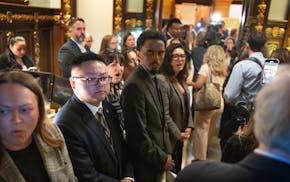 Democratic lawmakers interrupt the budget news conference chanting, “One Minnesota Right,” outside of the governor's reception room Thursday.