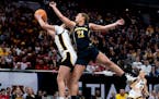 Taylor Woodson (21), making a play for Michigan against Iowa in the Big Ten tournament at Target Center, entered the transfer portal and will play for