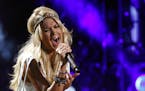 FILE - This June 9, 2013 file photo shows Carrie Underwood performing at the 2013 CMA Music Festival in Nashville, Tenn. On Sept. 8, Underwood will si