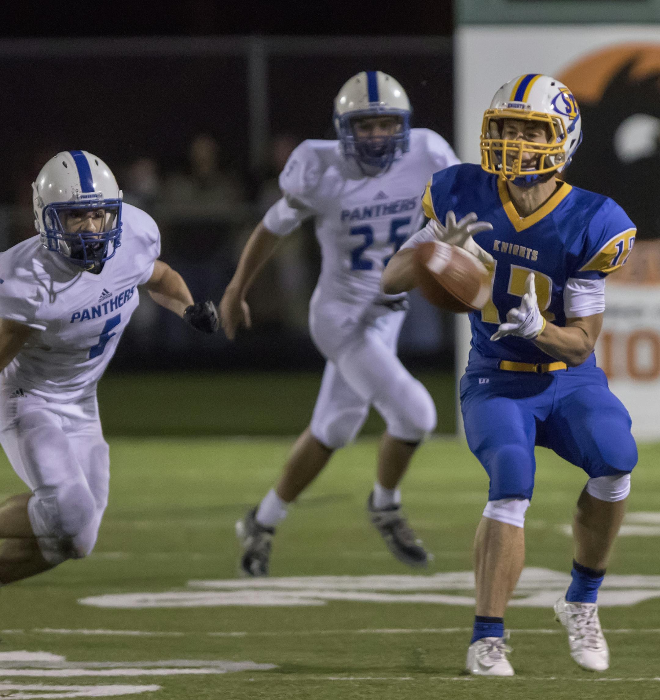 St. Michael-Albertville wide receiver Austin Veire (12) catches a critical pass to put the Knights in position to kick the game winning field goal as the Spring Lake Park Panthers faced the St. Michael-Albertville Knights in the Class 5A MSHSL Football playoffs. ] MATT BLEWETT &#xef; matt@mattebphoto.com - October 31, 2015, Osseo, MN, Spring Lake Park Panthers, St. Michael-Albertville Knights, Prep Football, Spring Lake Park Panthers vs St. Michael-Albertville Knights, 264495 PREP110115