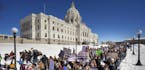Thousands of high school students march to the state Capitol in Saint Paul, Minn., after they walked out of their schools Wednesday, March 7, 2018, to