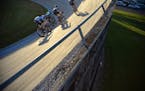 Single-speed bicycle racers compete at the Thursday Night Lights Race Thursday, June 25 at the National Sports Center's Velodrome in Blaine.