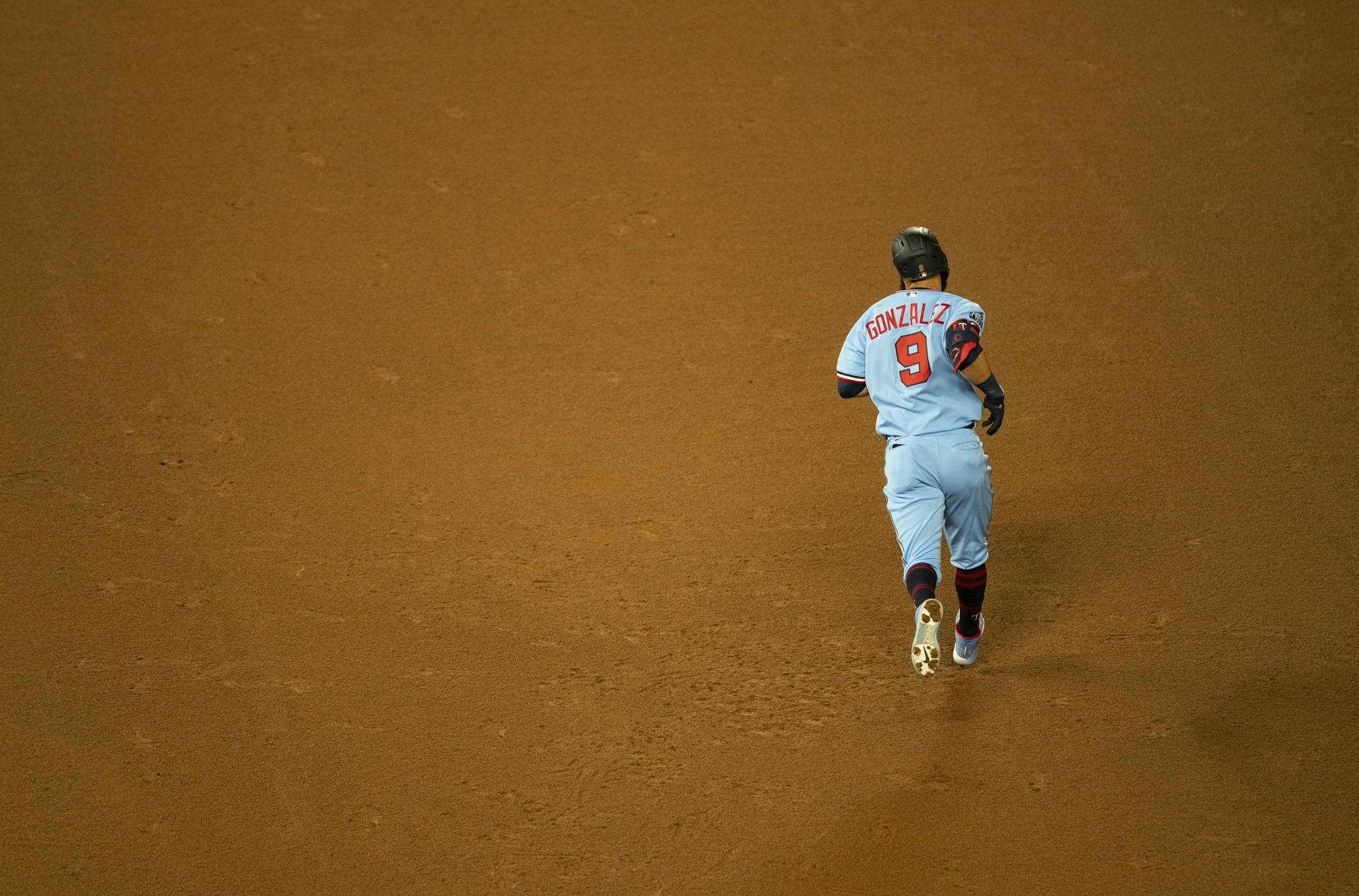 Minnesota Twins catcher Mitch Garver (8) jogged around the bases after hitting a solo home run in the bottom of the ninth inning.