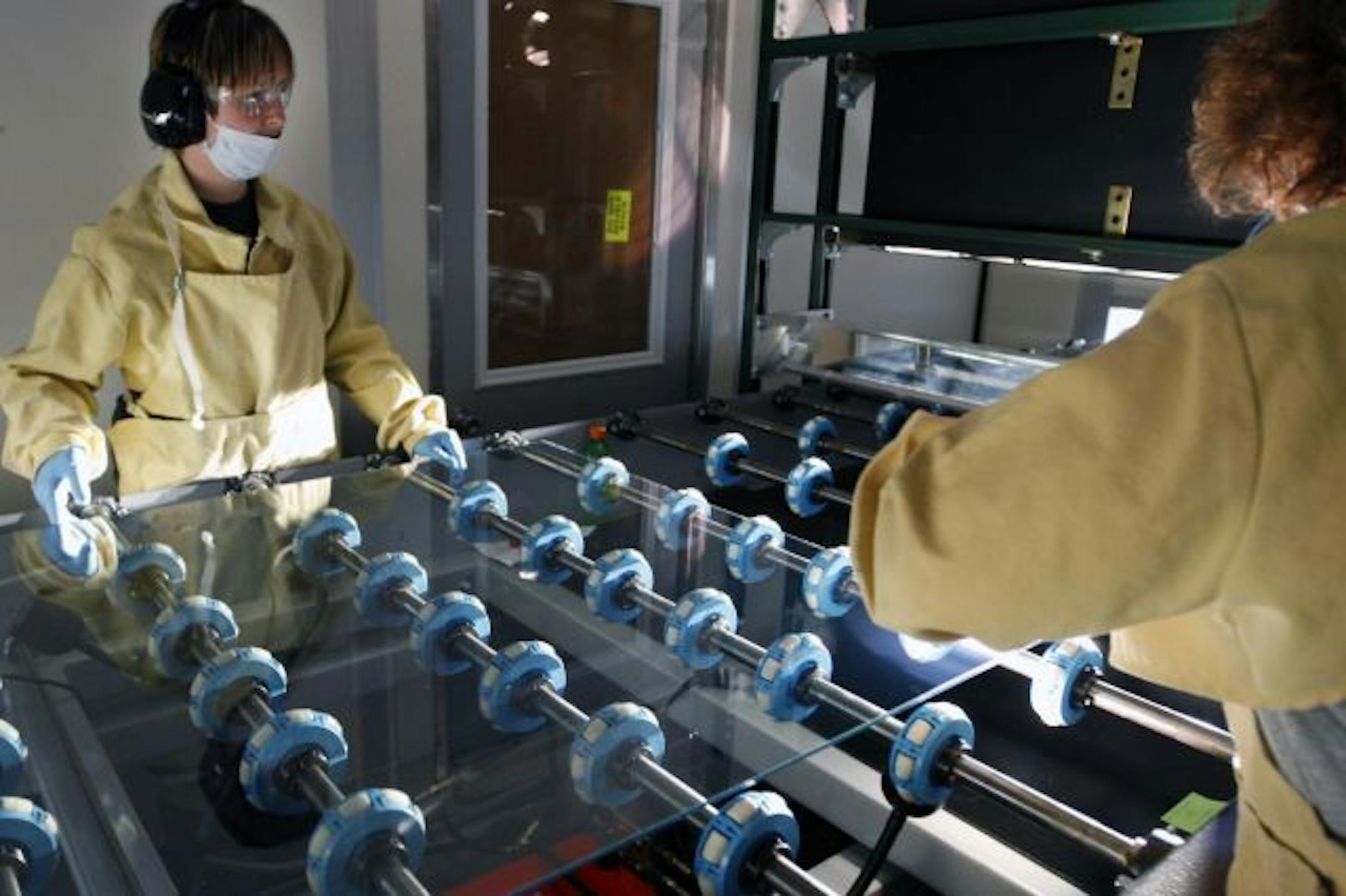 Richard Tsong-Taatarii/rtsong-taatarii@startribune.com 10/25/07,Fairbault, MN; left to right: At Sage Electrochromics, Shawna Westphal and Shelly Kubes inspect glass that will be fitted with proprietary technology that can control the amount of glare and heat at a push of a button.