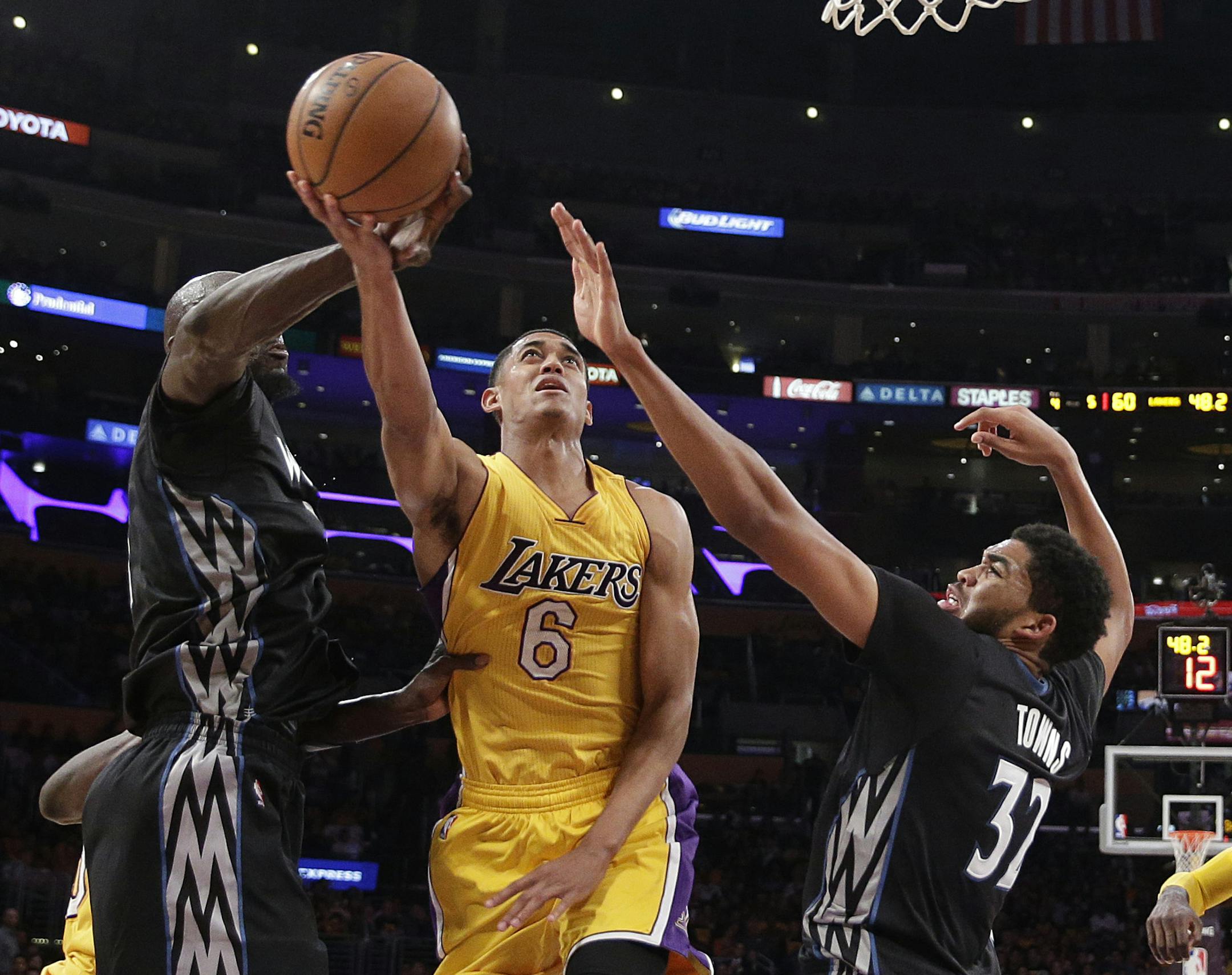 Los Angeles Lakers' Jordan Clarkson, center, gets his shot blocked by Minnesota Timberwolves' Kevin Garnett, left, as Timberwolves' Karl-Anthony Towns looks on during the first half of an NBA basketball game, Wednesday, Oct. 28, 2015, in Los Angeles. (AP Photo/Jae C. Hong) ORG XMIT: LAS108