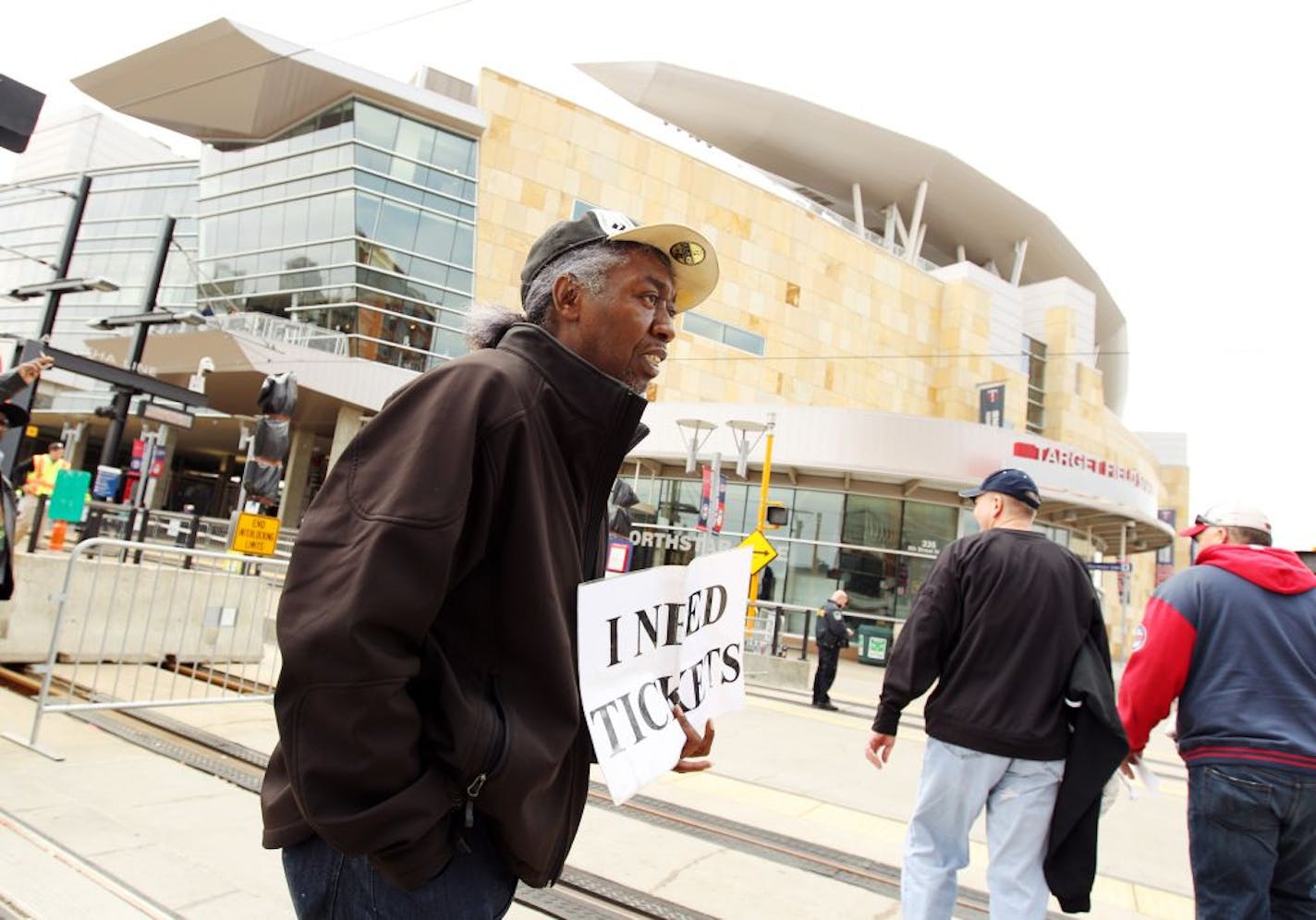 Andre Hollis, of St. Paul, tries to buy and sell tickets to a Twins game in front of Target Field on 5th Street in downtown Minneapolis, Sunday, April 29, 2012.