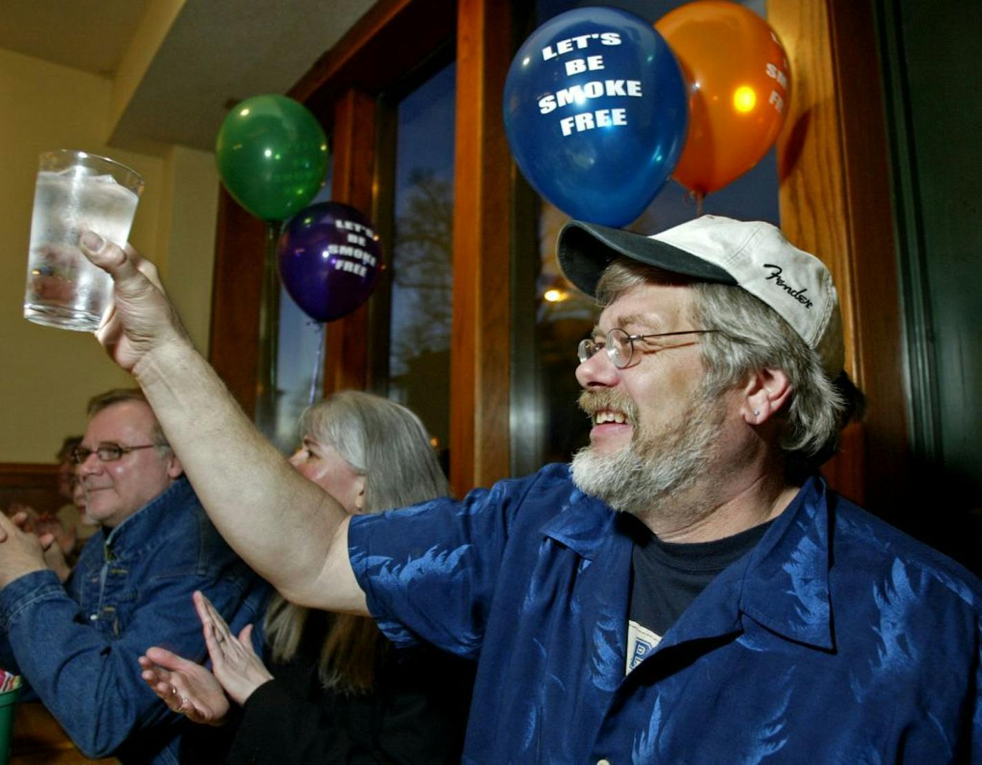 Dave Thune raises a glass of ice water in a toast celebrating the clean smoke-free air in the restaurant.