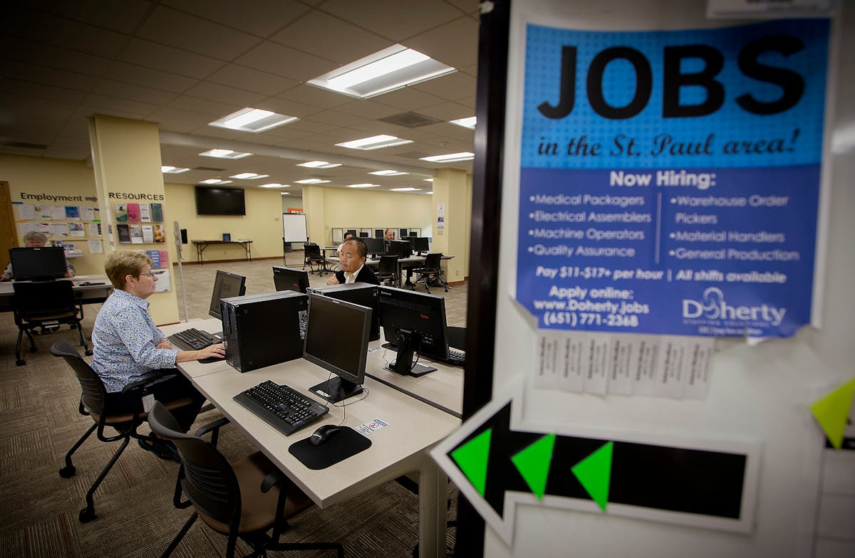 Dee Foutch, left, and Zachary Lee searched for jobs on computers at the Ramsey County Workforce Development Center on Thursday, Aug. 17, 2017, in Nort
