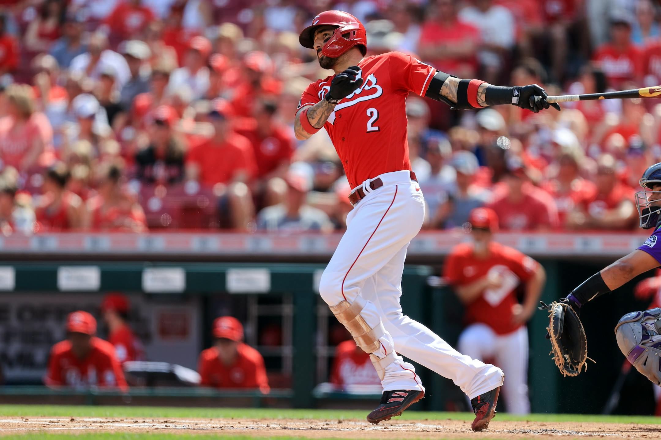 Cincinnati Reds' Nick Castellanos hits an RBI-double during the first inning of a baseball game against the Colorado Rockies in Cincinnati, Saturday, June 12, 2021. (AP Photo/Aaron Doster)