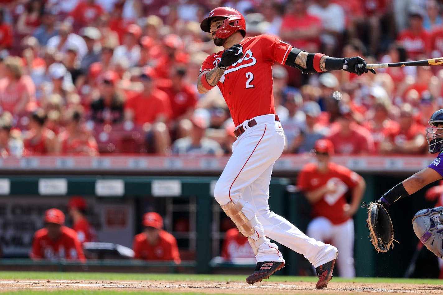 Cincinnati Reds' Nick Castellanos hits an RBI-double during the first inning of a baseball game against the Colorado Rockies in Cincinnati, Saturday, June 12, 2021. (AP Photo/Aaron Doster)