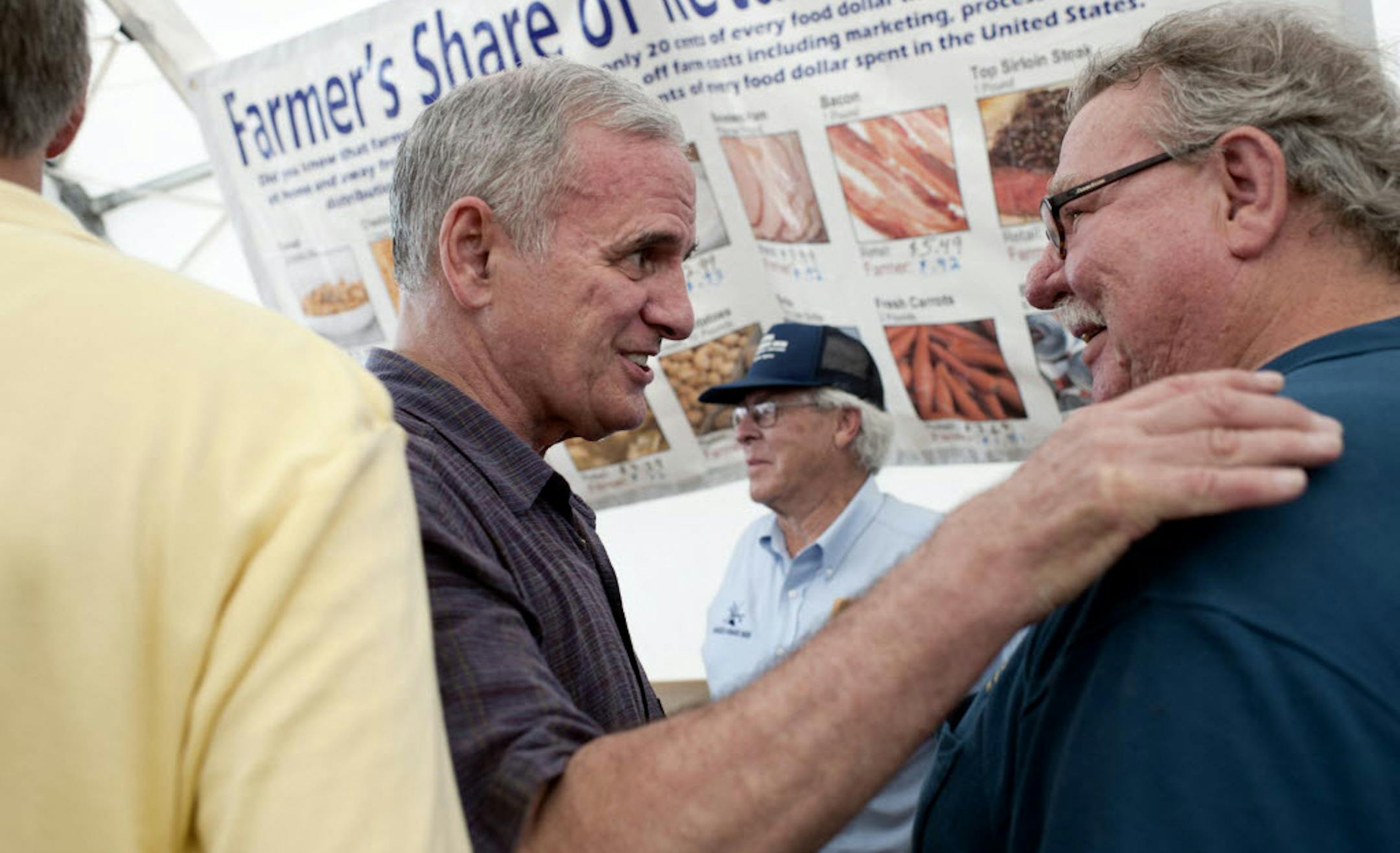 Gov. Mark Dayton chatted with Bruce Miller of the Minnesota Farmers Union during his visit to Farmfest on Tuesday.