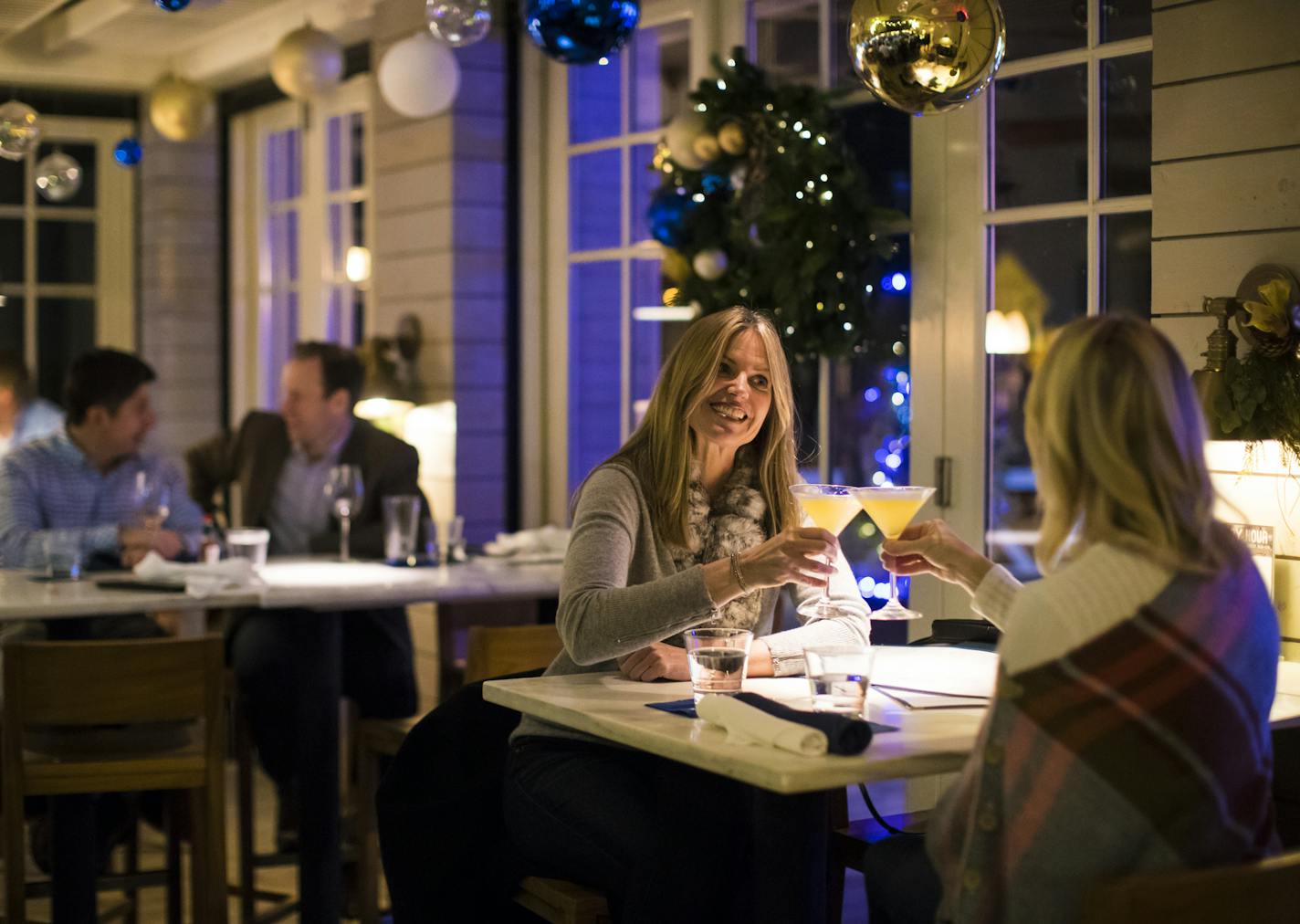 Kristina Schultz, left, raised her martini to toast with friend Dana Barry as they caught up over dinner at CoV in Wayzata on a recent Thursday evening. "Wayzata has changed," local restaurateur Ryan Burnet said. "It's not the quiet town it used to be. The bar has been raised."