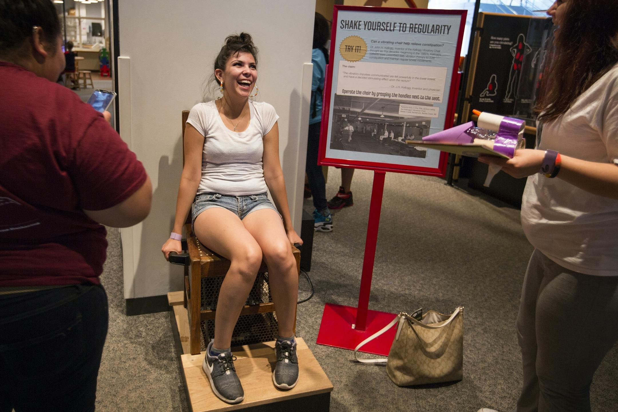 Shania Thompson, 18, of Minneapolis tries out a shaking chair, once thought of as a cure for constipation, at the Science Museum of Minnesota in St. Paul on Tuesday, June 30, 2015.