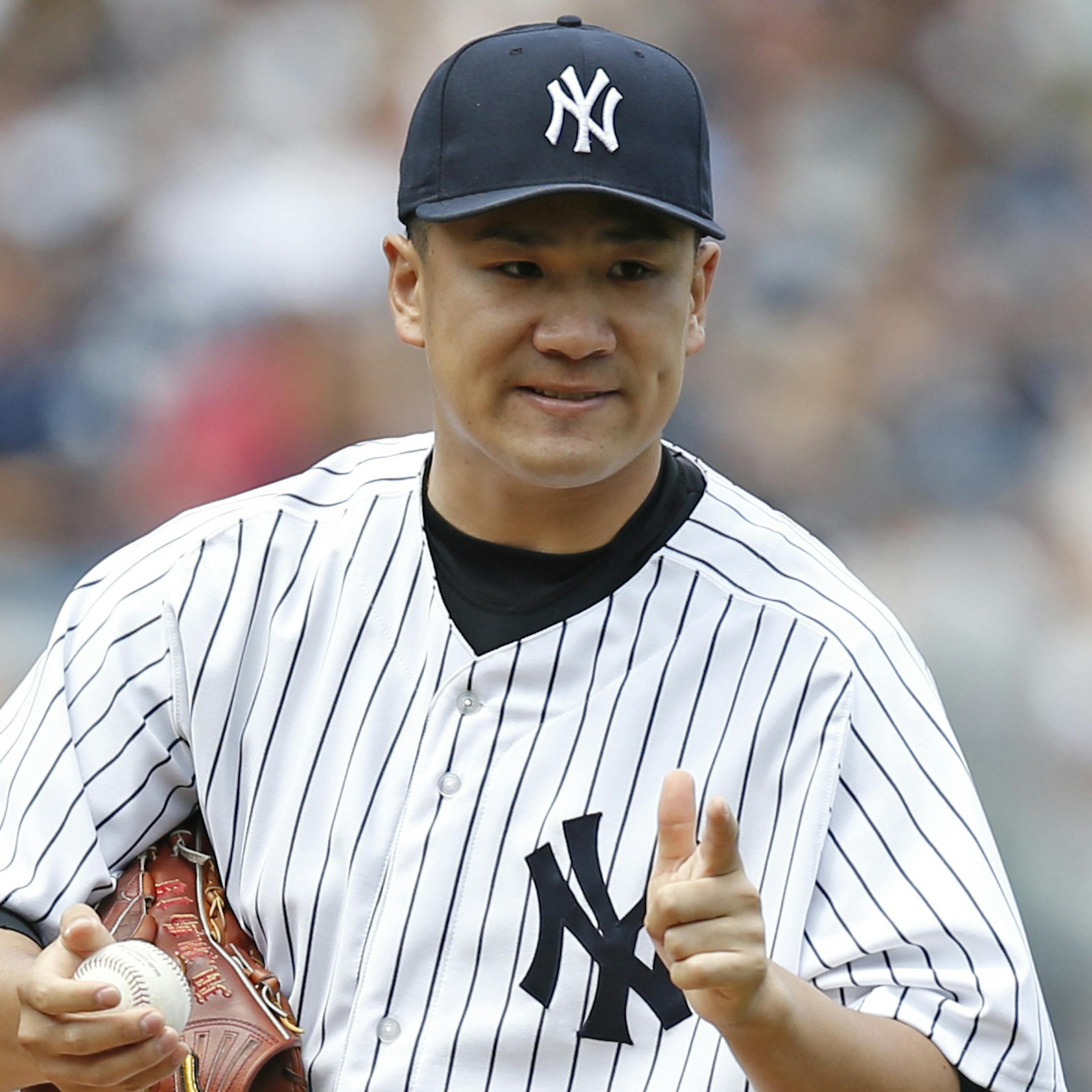 New York Yankees starting pitcher Masahiro Tanaka gestures to the first baseman in a baseball game against the Baltimore Orioles at Yankee Stadium in New York, Sunday, June 22, 2014. (AP Photo/Kathy Willens)