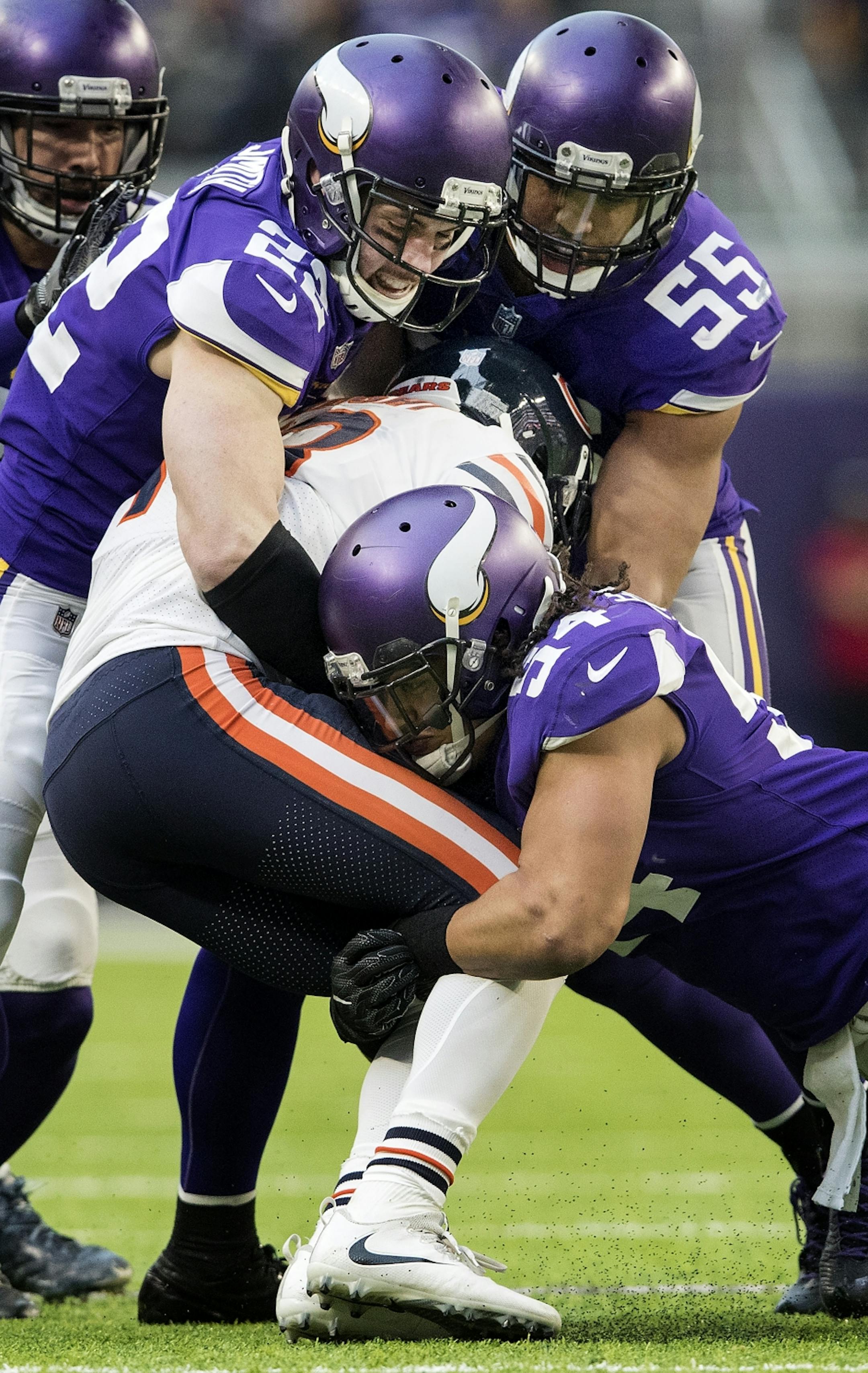 Harrison Smith (22), Anthony Barr (55) and Eric Kendricks tackled Kendall Wright (13) in the third quarter.