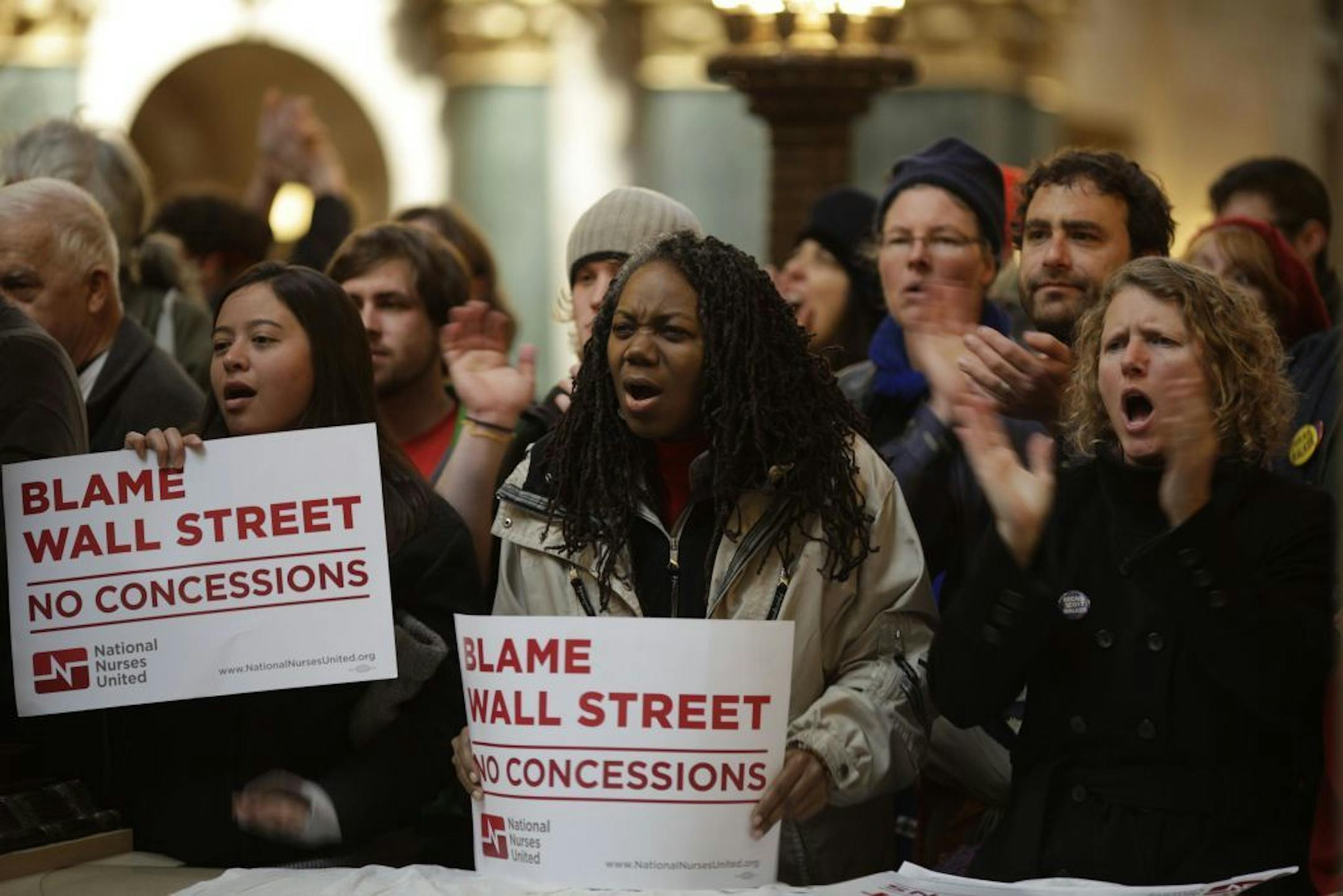Protesters shout outside the Assembly chamber at the Wisconsin Capitol in Madison, Wis., March 10, 2011. As thousands of demonstrators converged on the capitol, the police cut off access to the building on Thursday, creating a taut atmosphere in which Republican State Assembly members were seeking to maintain order long enough to vote on a bill that sharply curtails bargaining rights for government workers.