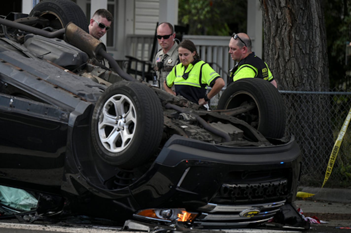 Hennepin County sheriff's deputies spoke to a paramedic and EMS worker near a crashed vehicle at 53rd Avenue North and Humboldt on Friday in Brooklyn Center. Brooklyn Center police say they were in pursuit of a murder suspect when the suspect crashed into an unrelated vehicle with four passengers. All five people involved in the crash were injured and transported to local hospitals; all were in stable condition.