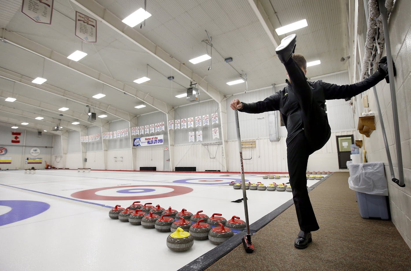 Pete Fenson stretched out before a practicing at the Bemidji Curling Club.