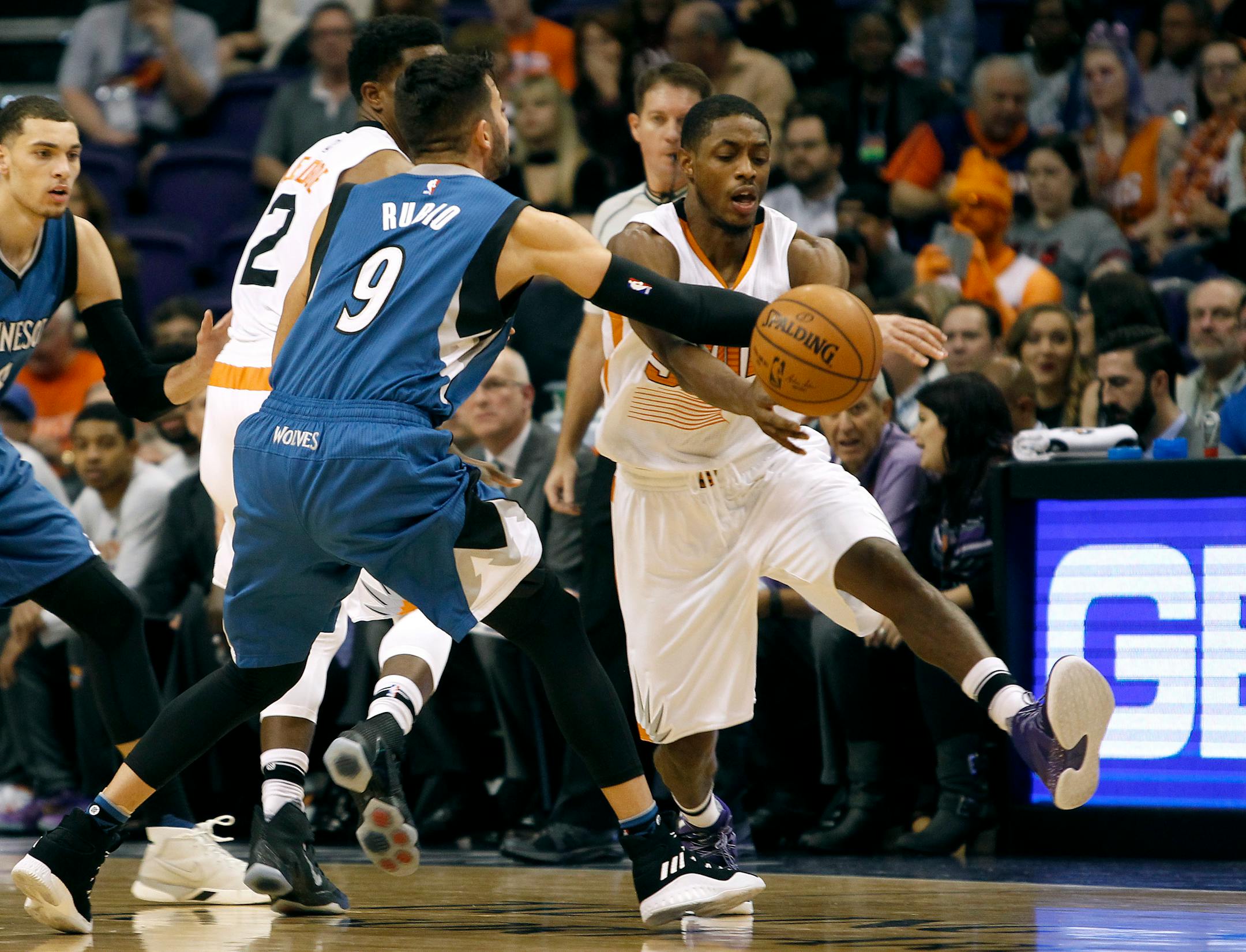 Phoenix Suns guard Brandon Knight, right, has the ball knocked away by Minnesota Timberwolves' Ricky Rubio during the first half of an NBA basketball game, Friday, Nov. 25, 2016, in Phoenix. (AP Photo/Ralph Freso)