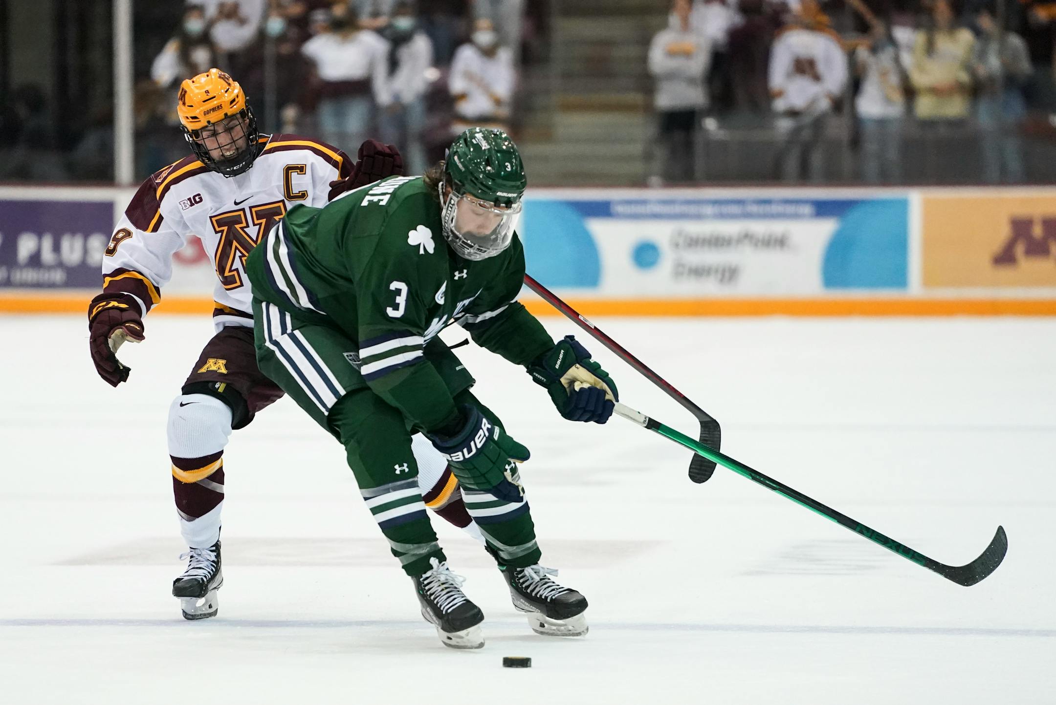 Minnesota forward Sammy Walker (9) maneuvered the puck around Mercyhurst Jak Beaune (3) during a drive in the second period.