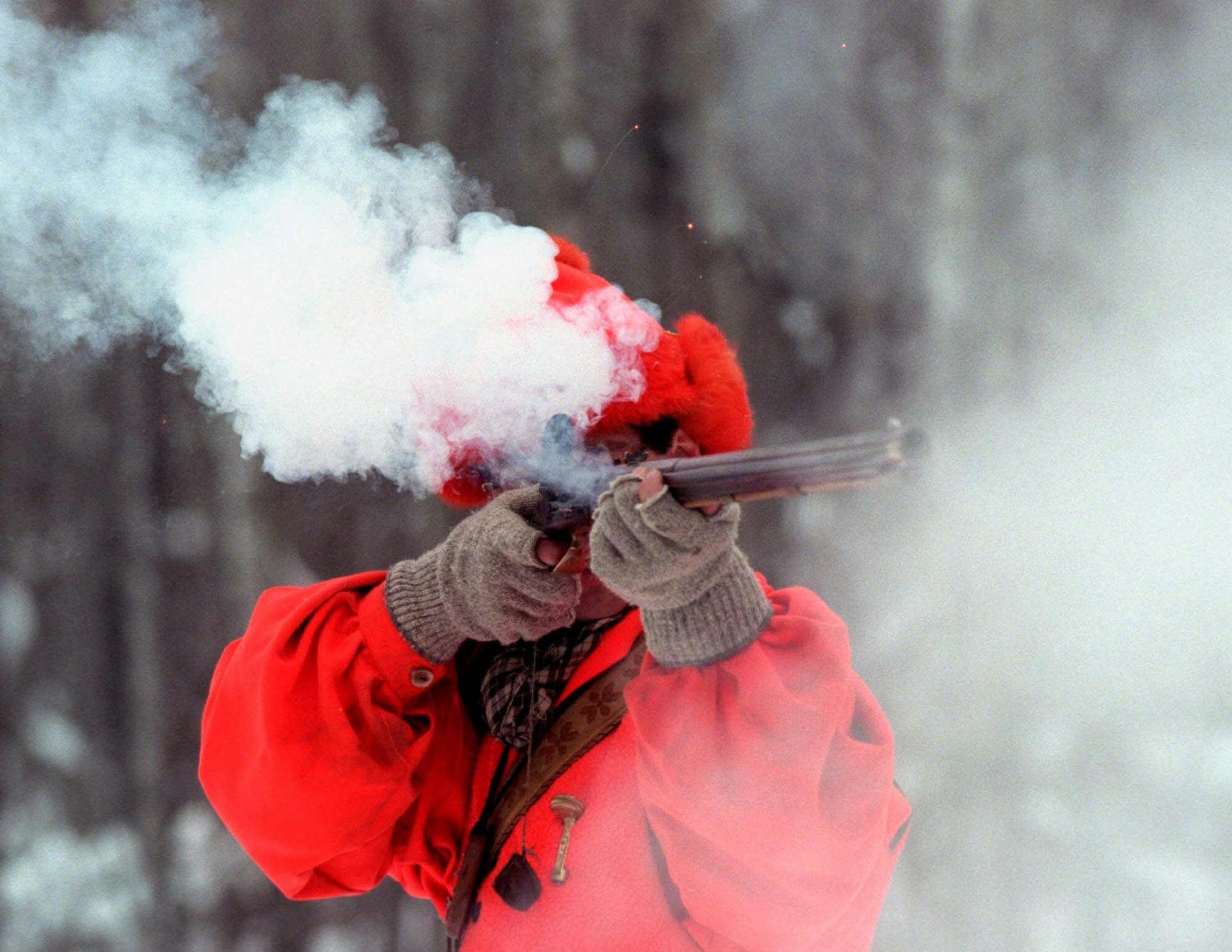 John Hayes disappears in a cloud of smoke when he fires his Virginia flintlock .54-caliber muzzleloader in Grand Rapids, Minn., Monday Nov. 21. 2000. Hayes, 38, will be among the nearly 10,000 Minnesota deer hunters who will be in the woods Saturday for the opening of the muzzleloader deer season. The season runs through Dec. 10.(AP Photo/Star Tribune, Tom Sweeney)