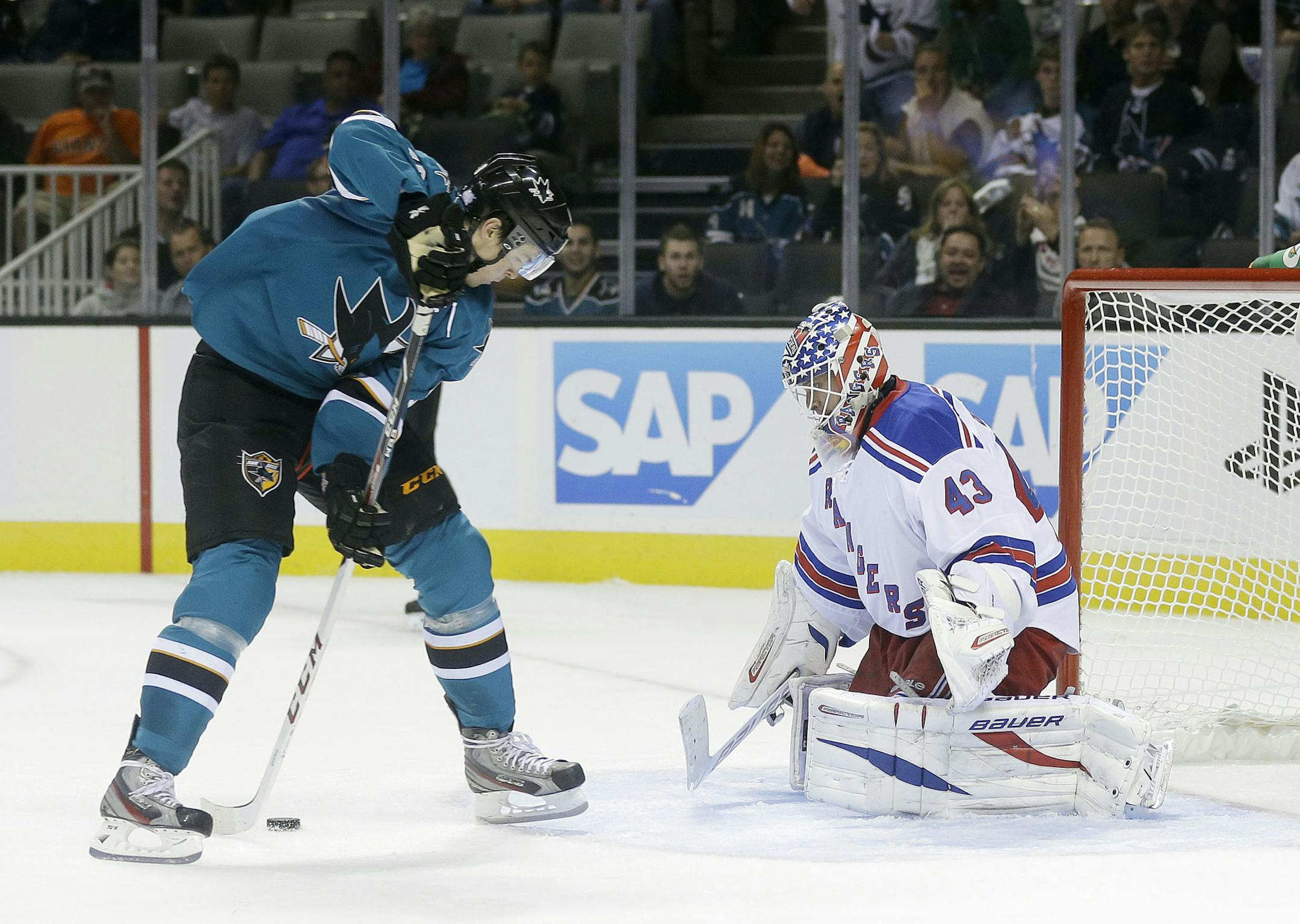 San Jose Sharks' Tomas Hertl, left, of the Czech Republic, scores his fourth goal of the game past New York Rangers goalie Martin Biron (43) during the third period of an NHL hockey game on Tuesday, Oct. 8, 2013, in San Jose, Calif. (AP Photo/Marcio Jose Sanchez)