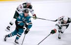 San Jose Sharks right wing Timo Meier (28) battles for the puck against Minnesota Wild defenseman Carson Soucy (21) during the third period of an NHL 