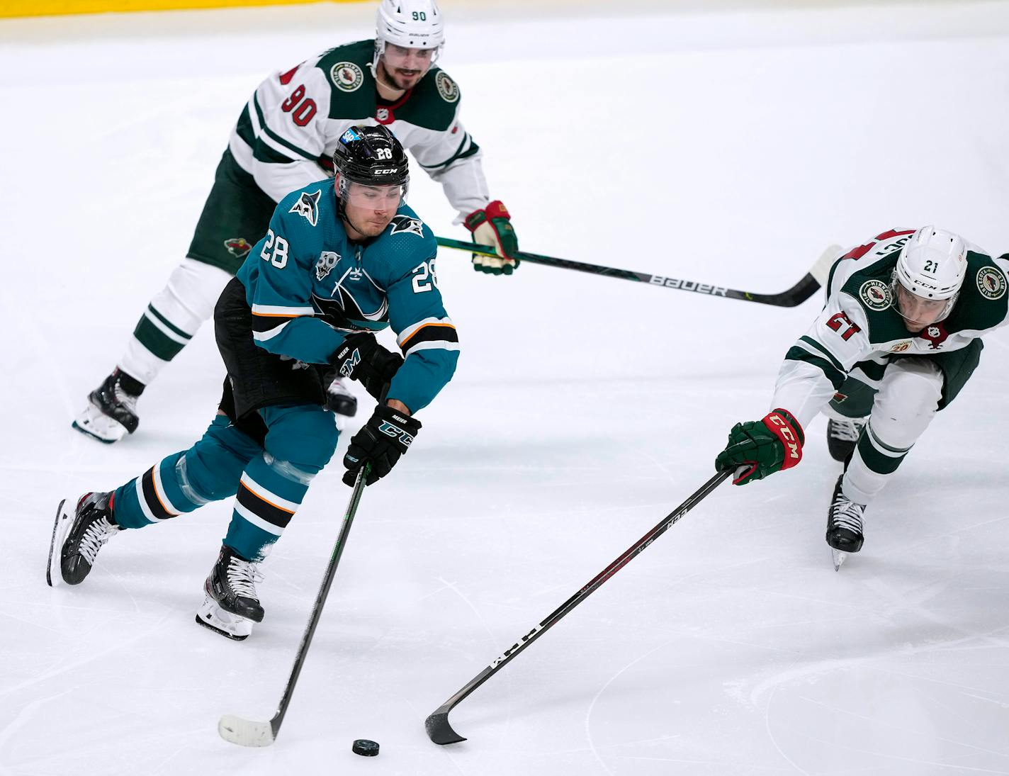 San Jose Sharks right wing Timo Meier (28) battles for the puck against Minnesota Wild defenseman Carson Soucy (21) during the third period of an NHL hockey game in San Jose, Calif., Monday, March 29, 2021. (AP Photo/Tony Avelar)