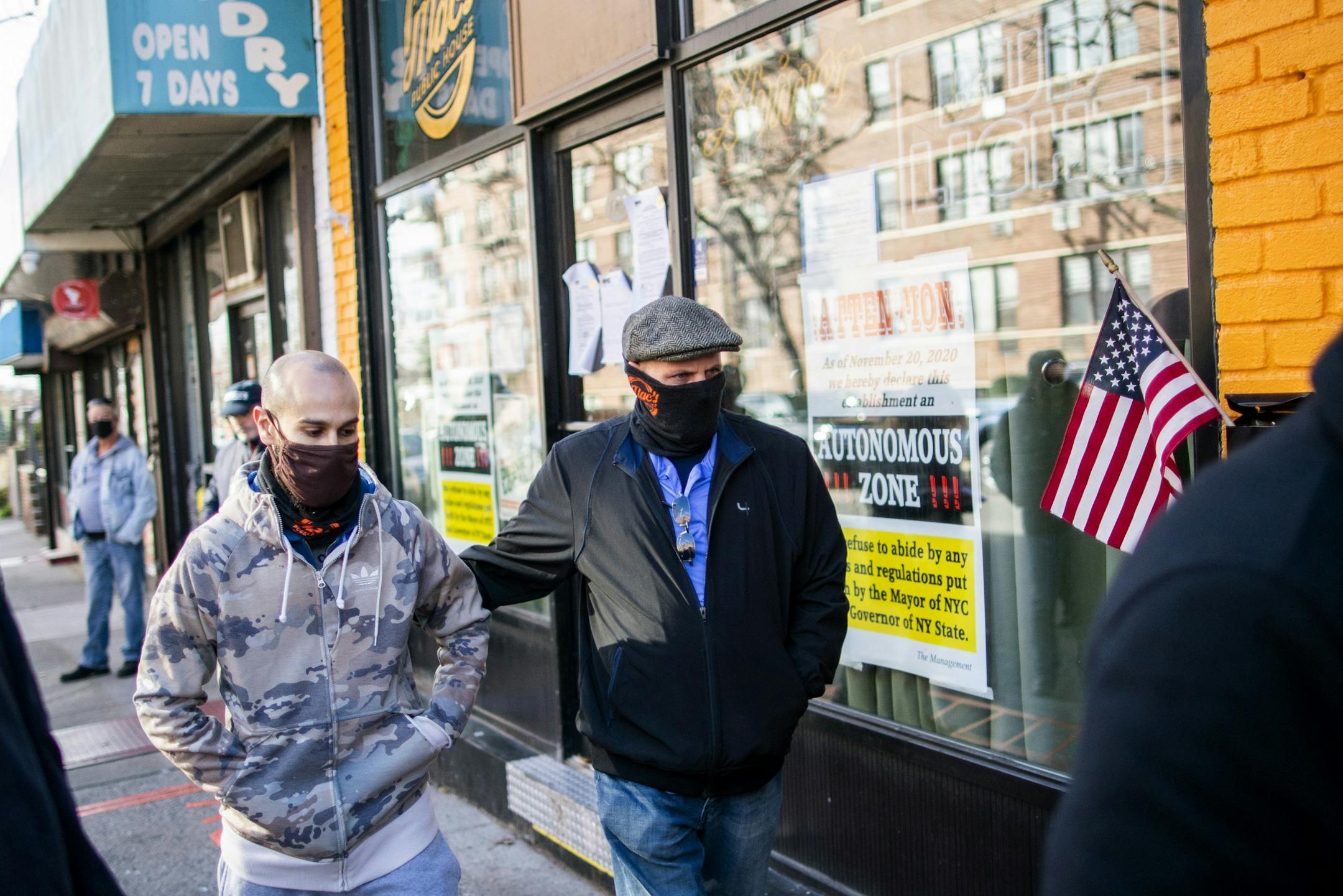 Co-owners of Mac's Public House Keith McAlarney, right, and Danny Presti walk away at the end of a press conference outside their closed bar that was defying coronavirus restrictions on Staten Island Monday, Dec. 7, 2020, in New York. Authorities in New York City said Presti was arrested early Sunday, Dec. 6 after running over a deputy with his car.