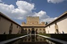 Tourists visit the the Comares Palace at the Alhambra in Granada, Spain.