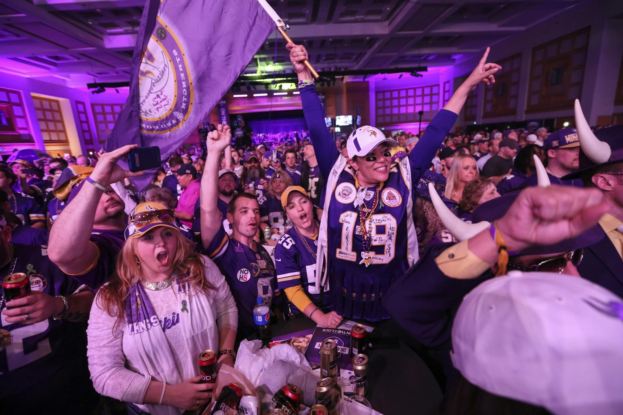 Fans, including Margi Patton holding the flag, who came up from Florida to watch the draft with her Vikings friends, celebrated as it was announced the Vikings' pick was in on Thursday, April 30, 2015, at the Vikings Draft Party at the Convention Center in Minneapolis.