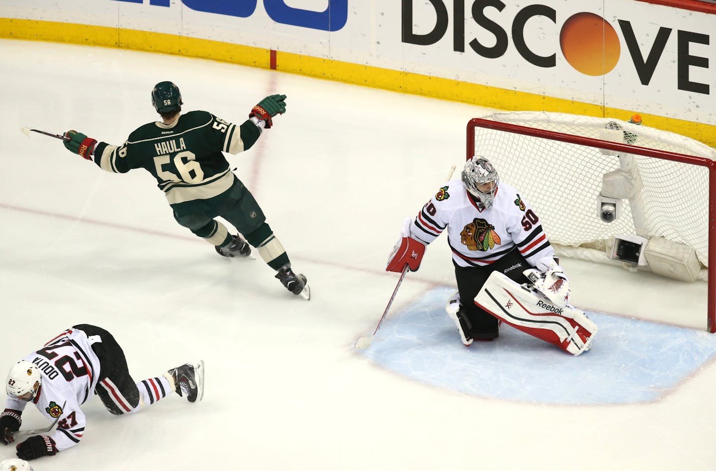 Minnesota Wild left wing Erik Haula (56) started to celebrate after scoring on Chicago Blackhawks goalie Corey Crawford (50) to tie the game during the second period of their game Tuesday night at Xcel Energy Center in St. Paul.