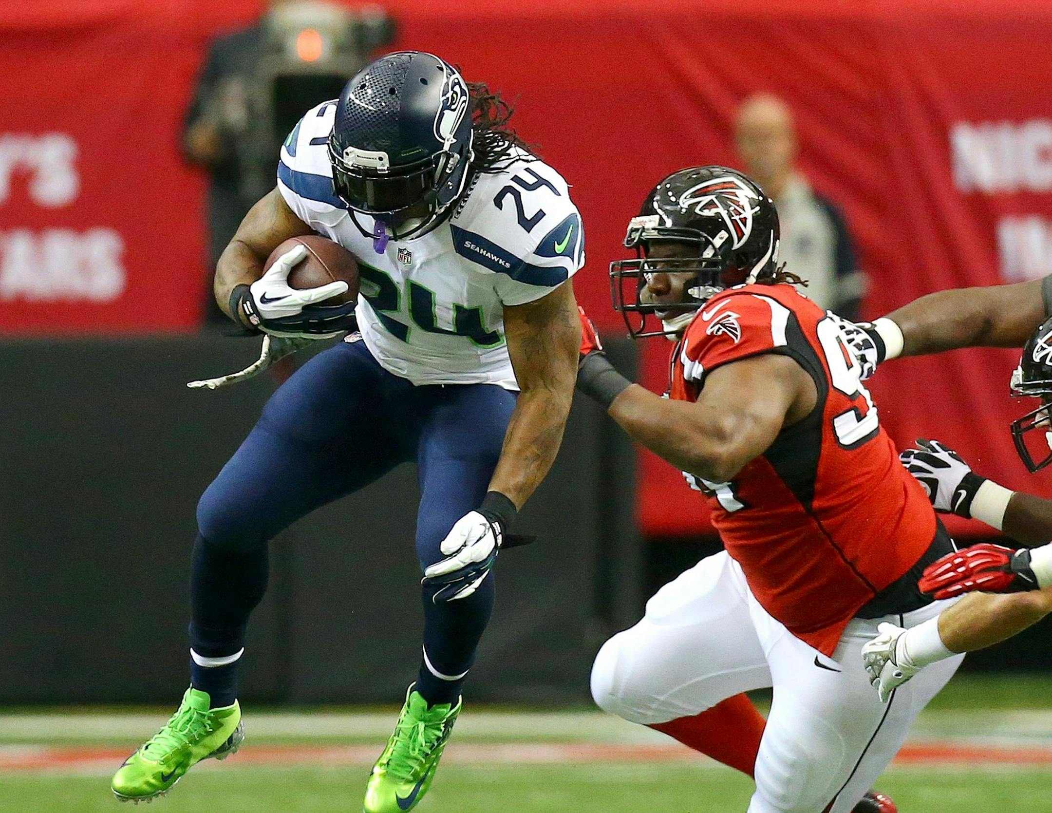 Running back Marshawn Lynch, left, of the Seattle Seahawks gets past Peria Jerry of the Atlanta Falcons for a first down in the first half of at the Georgia Dome iin Atlanta, Sunday, Nov. 10, 2013. The Seahawks defeated the Falcons, 33-10. (Curtis Compton/Atlanta Journal-Constitution/MCT)