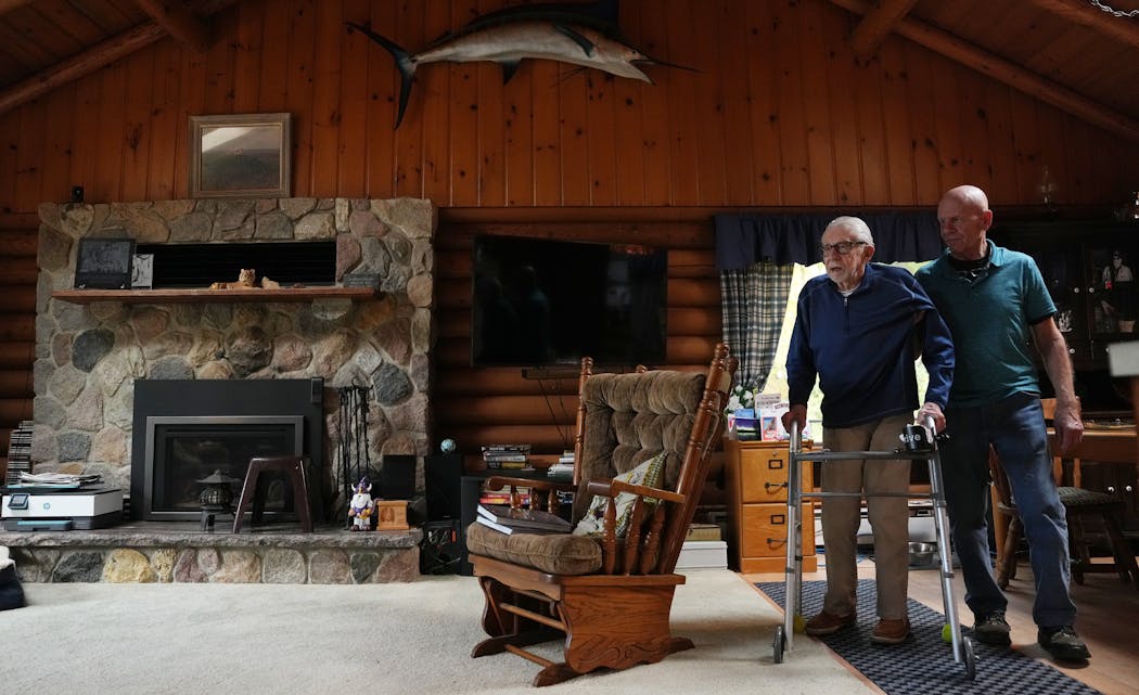 Jim Eide got help from oldest son Steve at home in Longville, Minn. For World War II veterans, “that was another life, but it was part of their life — it wasn’t part of ours,” Steve Eide said.