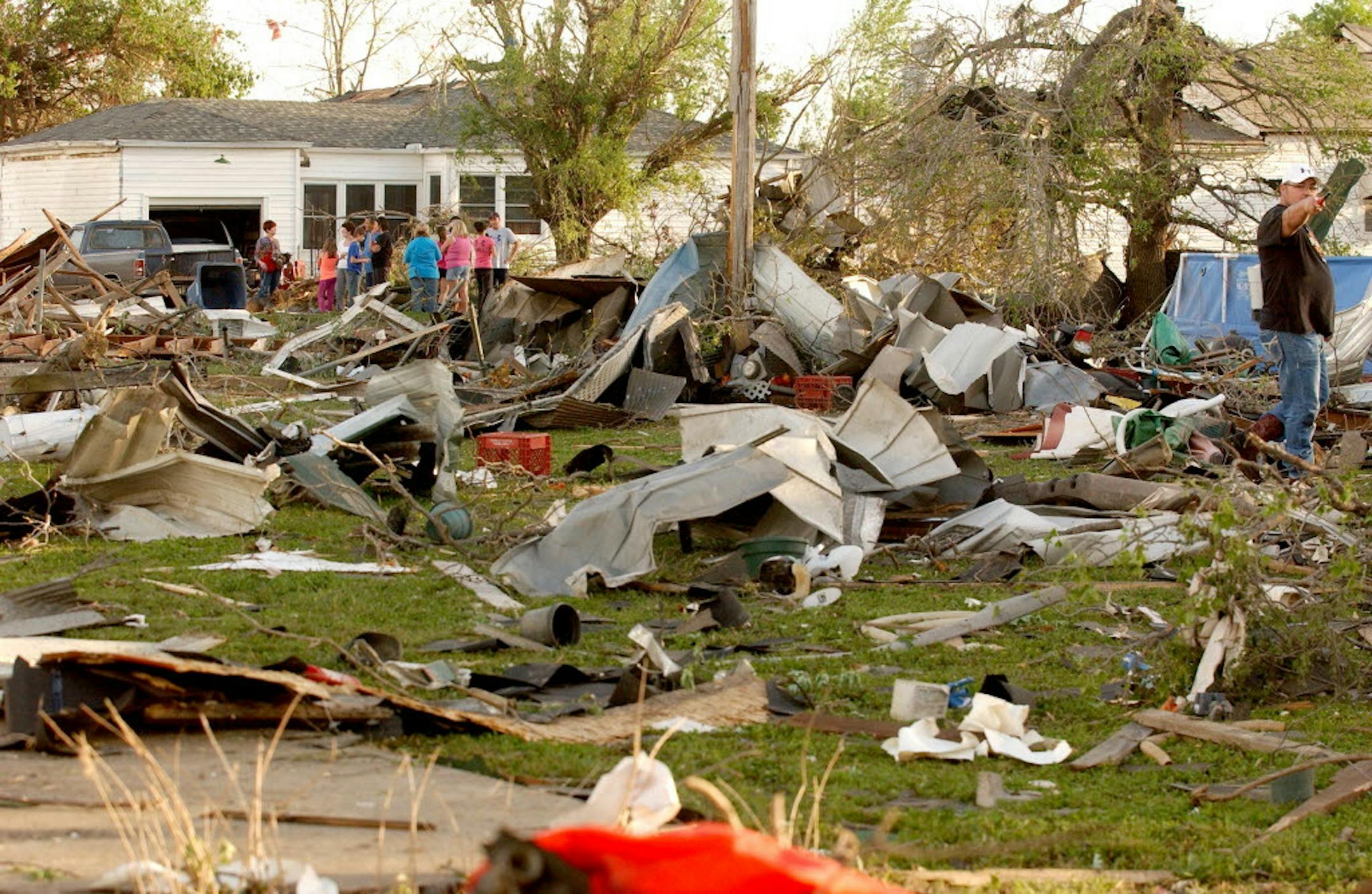 April 27, 2014: Quapaw, Okla., residents survey the damage in a residential neighborhood struck by a tornado on Sunday evening.
