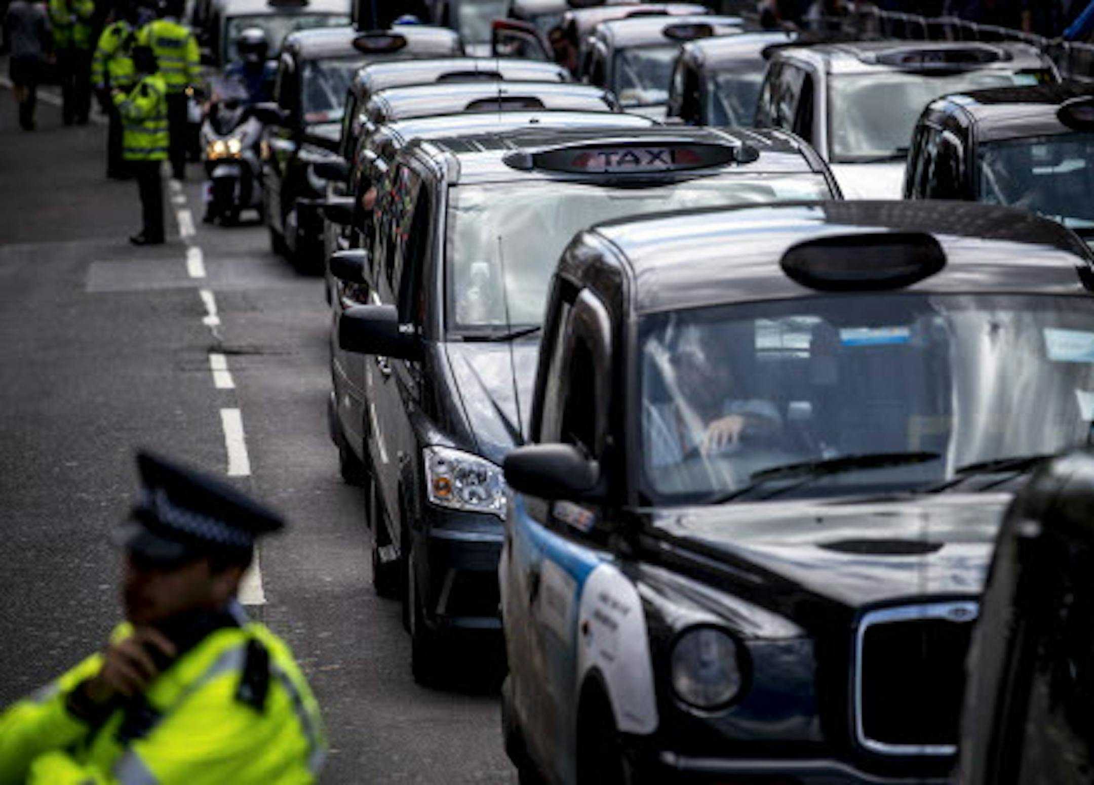 London taxi drivers bring their cabs to a halt in a protest aimed at the smartphone-based cab service Uber, June 11, 2014. Cabbies in a half-dozen cities European blocked roads on Wednesday, upset that regulators are not doing their part to ensure fair competition between Uber and traditional operators. (Andrew Testa/The New York Times)