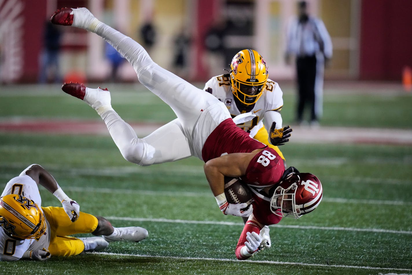 Indiana tight end A.J. Barner (88) is tackled in front of Minnesota defensive back Justus Harris (21) in the second half during an NCAA college football game in Bloomington, Ind., Saturday, Nov. 20, 2021. (AP Photo/AJ Mast)