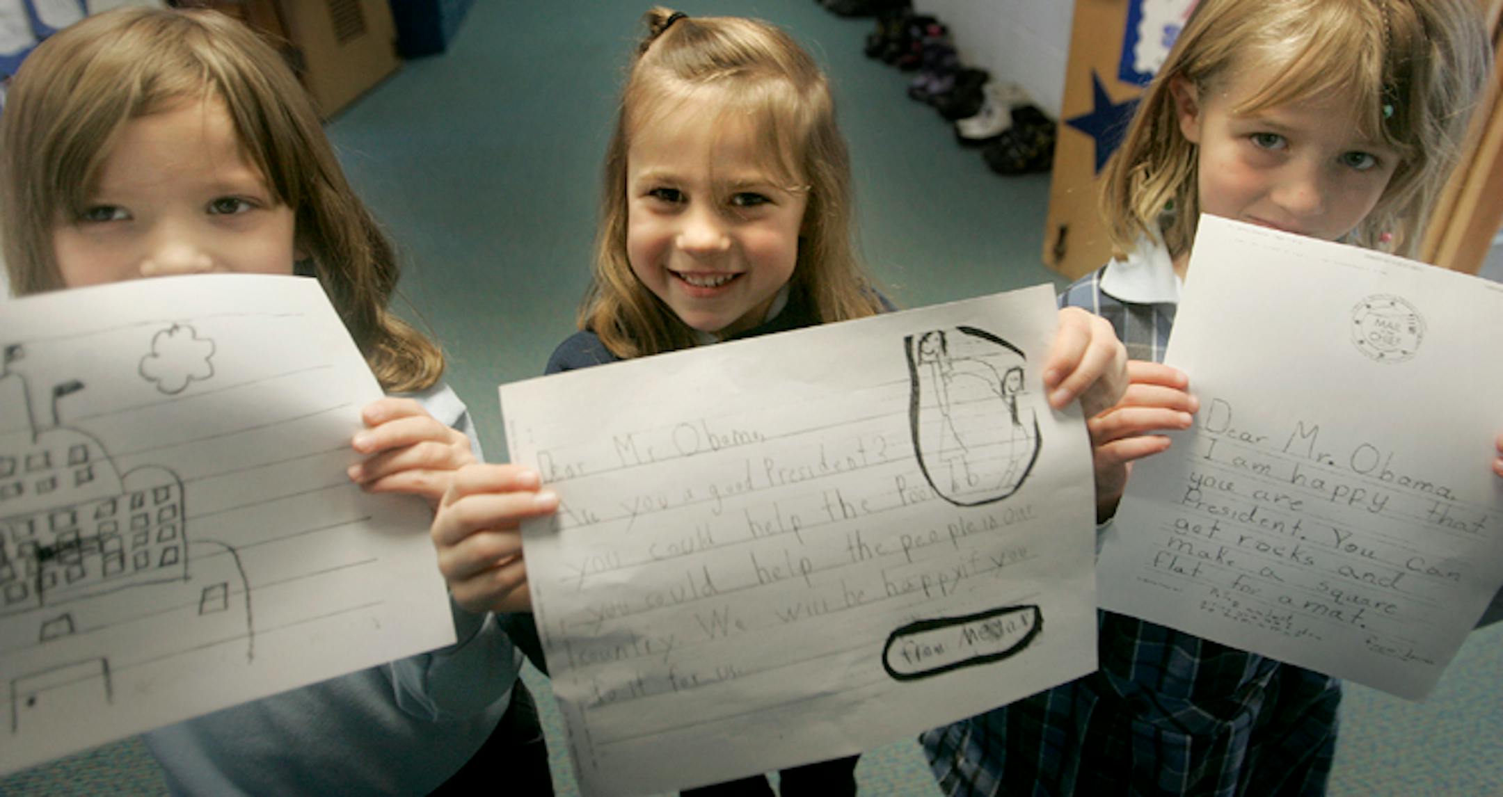 On Monday, St. John the Baptist first-graders Jessica Glamm, 6, left, Megan Thienes, 6, center, and Jessica Norton, 7, showed off letters they wrote to President Obama in November.
