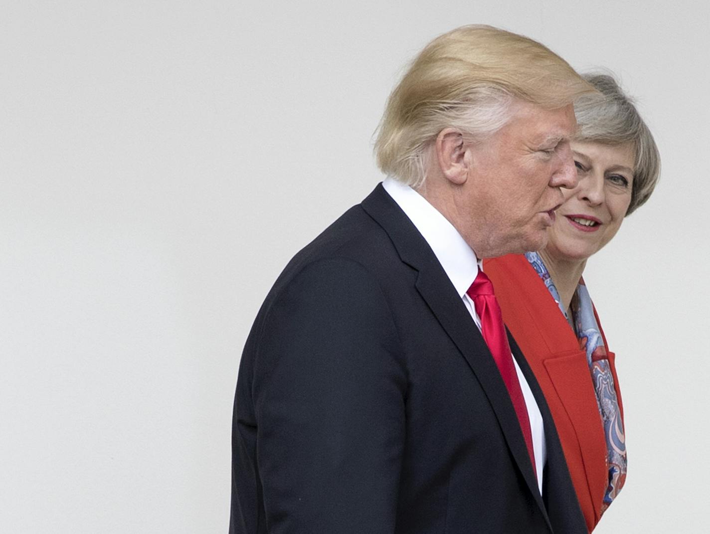 President Donald Trump and British Prime Minister Theresa May walk along the West Wing Colonnade at the White House in Washington, Jan. 27, 2017. (Stephen Crowley/The New York Times)