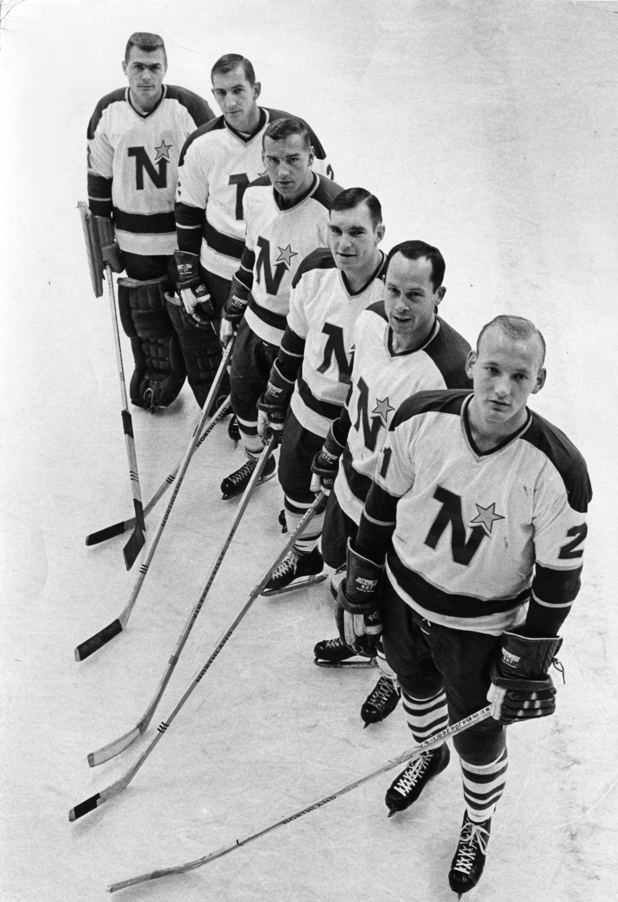 Bill Goldsworthy (right), who scored the North Stars' first goal, with the team's first starting lineup: (from left) goalie Gary Bauman, Bob Woytowich, Dave Balon, Andre Boudrias, and Mike McMahon.