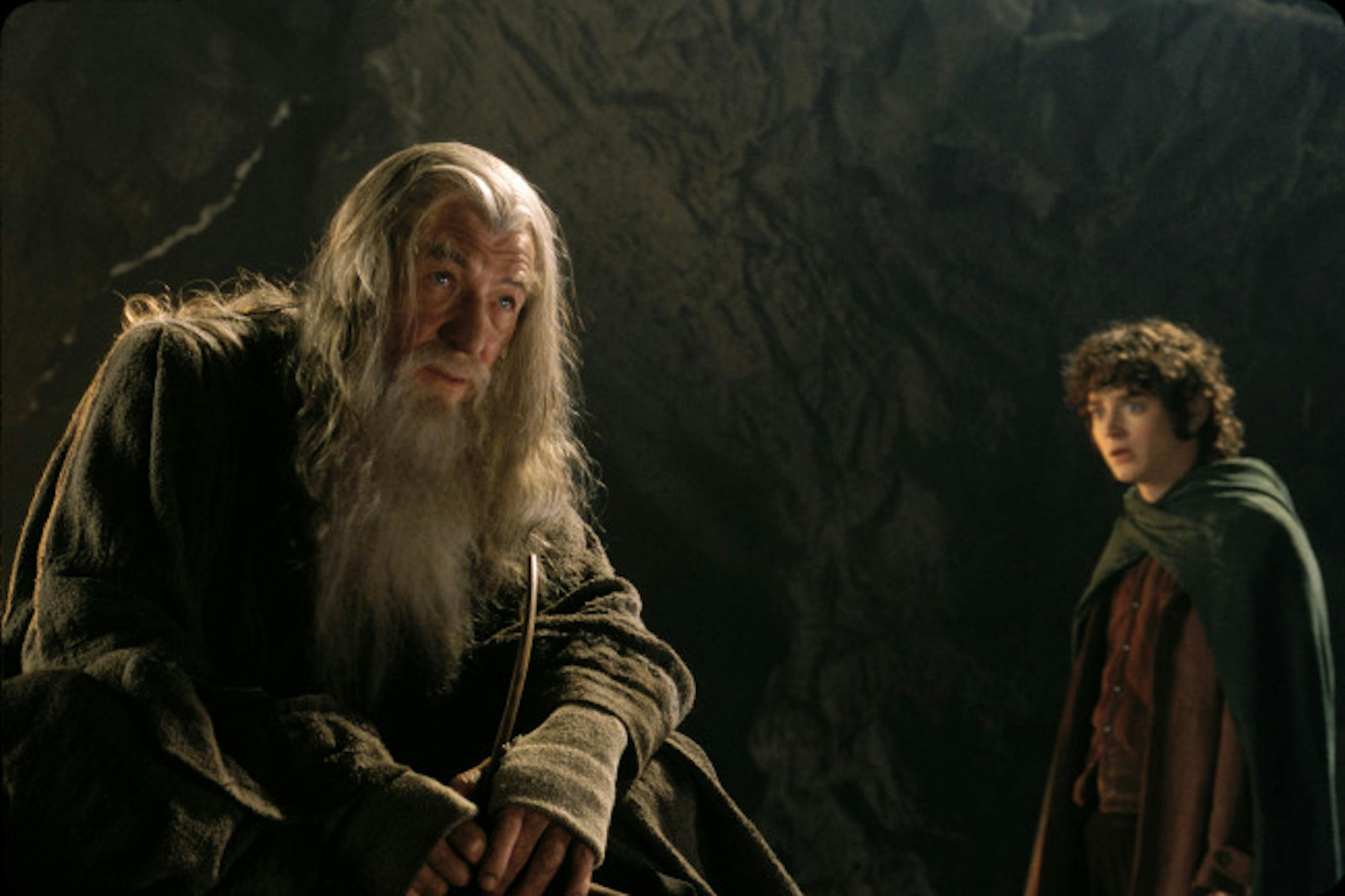 Gandalf (Ian McKellen) guides Frodo (Elijah Wood) through the perilous caverns of Middle-earth in New Line Cinema's epic adventure, THE LORD OF THE RINGS: THE FELLOWSHIP OF THE RING.