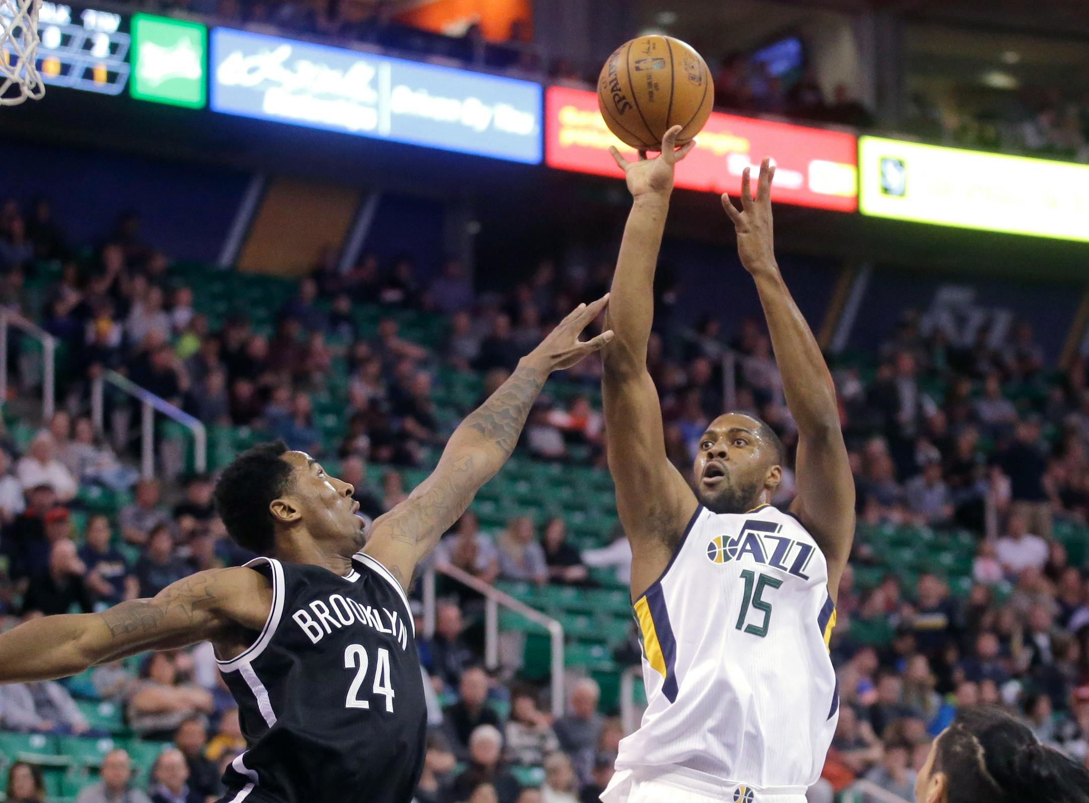 Utah Jazz forward Derrick Favors (15) shoots as Brooklyn Nets forward Rondae Hollis-Jefferson (24) defends during the first half of an NBA basketball game Friday, March 3, 2017, in Salt Lake City. (AP Photo/Rick Bowmer)