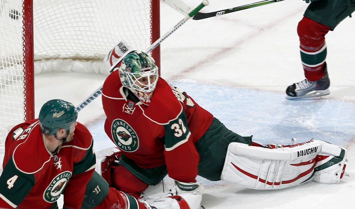 Wild goalie Niklas Backstrom lets in a goal by Vancouver's Mason Raymond in the second period.