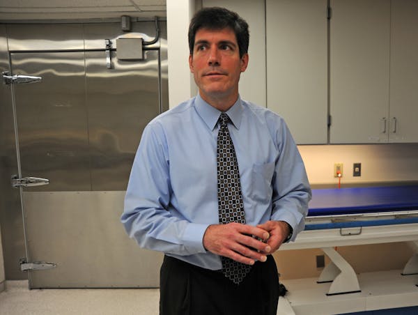 Dr. Andrew Baker is being reappointed to another four-year term as Hennepin County's medical examiner at a time of possible change for the department.