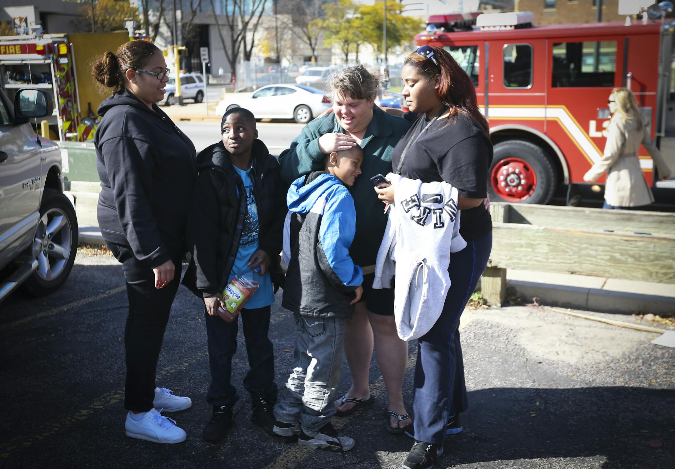Center; Diane Tyrrell hugged her grandson Rashard Ashmean Jr. as she stood with family who came to see her after she escaped an apartment fire that appeared to have started in the apartment below her and her husbands on Sunday, October 19, 2014 in downtown Minneapolis, Minn. ] RENEE JONES SCHNEIDER • reneejones@startribune.com