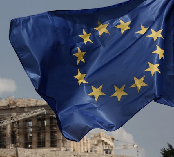 A European Union (EU) flag flutters in front of the temple of the Parthenon in Athens, Greece, Saturday, Aug. 15, 2015. Finance ministers of the 19-na