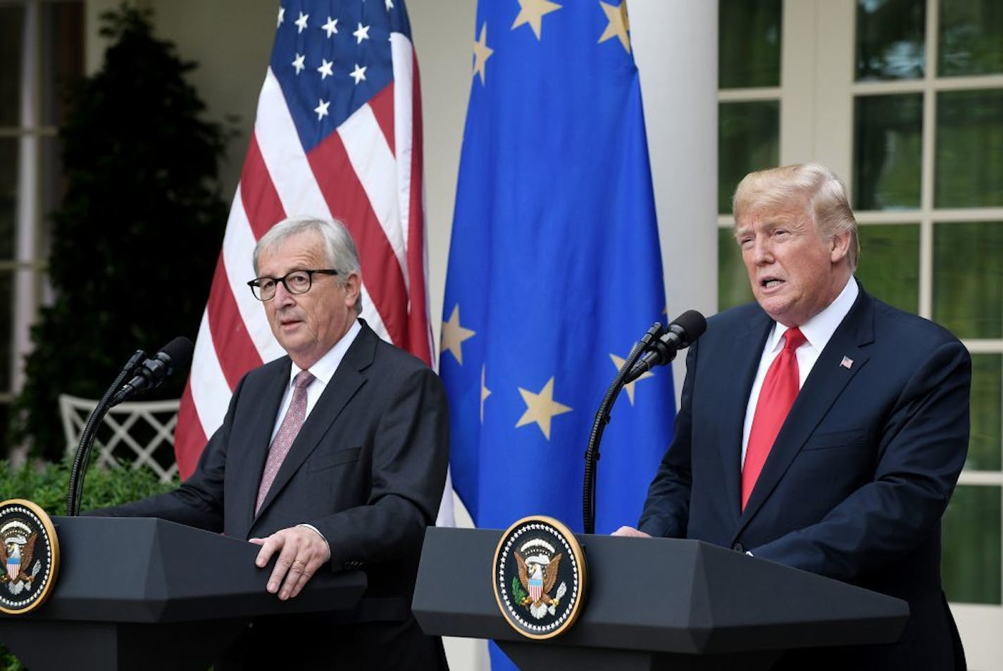 U.S. President Donald Trump speaks as European Commission President Jean-Claude Juncker looks on during a press conference on Wednesday, July 25, 2018 in the Rose Garden at the White House in Washington, D.C.