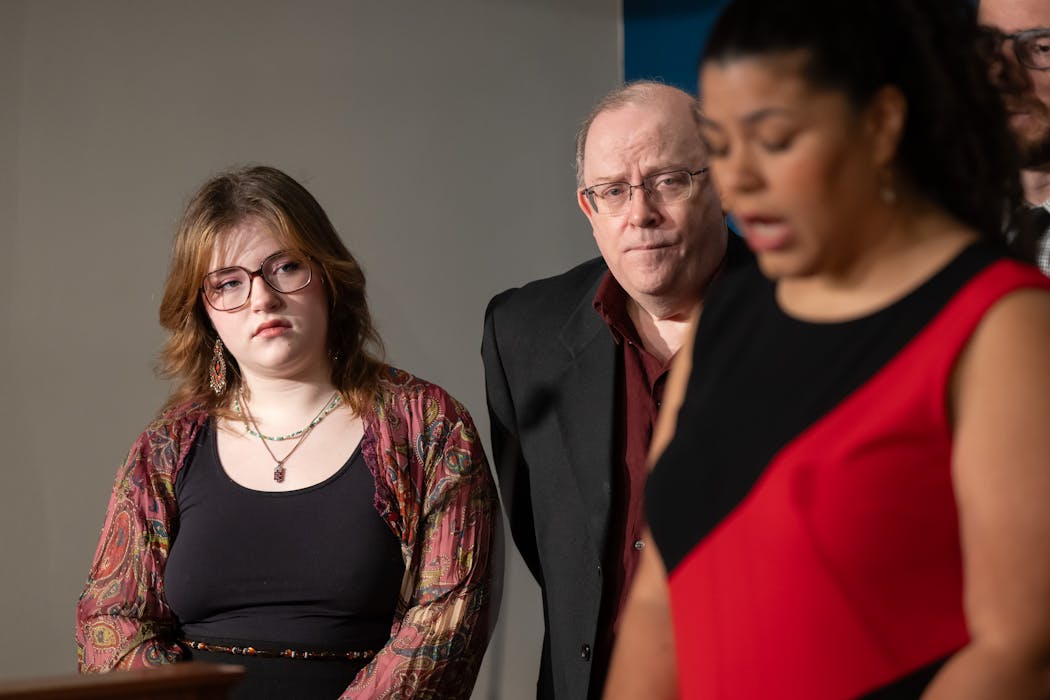 Nora Strande, Amara’s sister, and their father, Michael Strande, listen as Rep. Athena Hollins, DFL-St. Paul, speaks at a news conference on Wednesday.