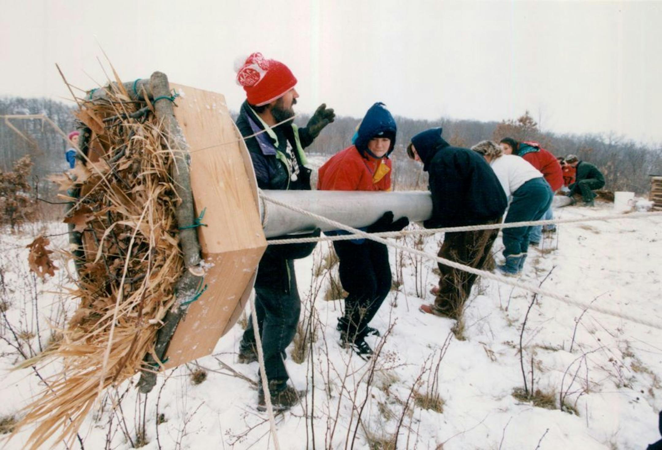 December 08, 1994 (far left) Randy Christman of the Raptor Resource Project directed middle team students from the Marcy Open Elementary School Minneapolis) as they hoisted the 30ft topiary est into a 6ft foundation hole for final patios ,, The students built the nest on grounds of the Lee and Rose Warner Nature Center, west of Marine St. Croix. Christman built the nest out of aluminum irrigation tubing which is easy to carry into the field and light enough fort he students to hoist into the hol