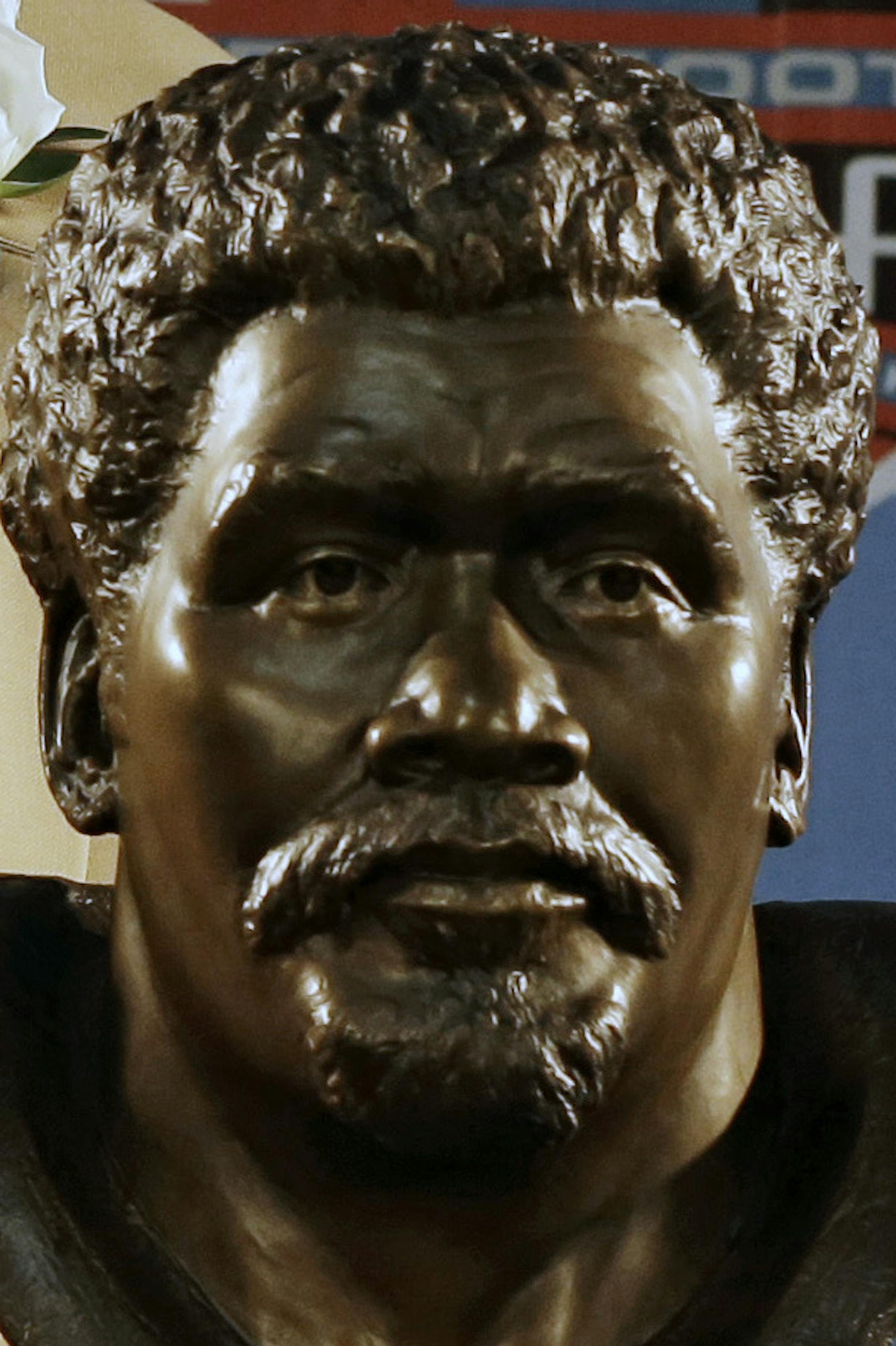 Hall of Fame Inductee Claude Humphrey poses with his bust during the 2014 Pro Football Hall of Fame Enshrinement Ceremony at the Pro Football Hall of Fame Saturday, Aug. 2, 2014, in Canton, Ohio. (AP Photo/Tony Dejak)